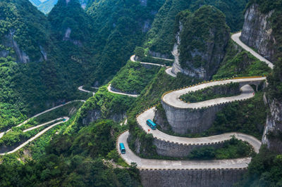 High angle view of winding road amidst trees