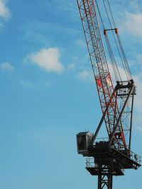 Low angle view of crane against sky