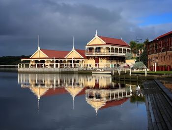 Reflection of building in lake against sky