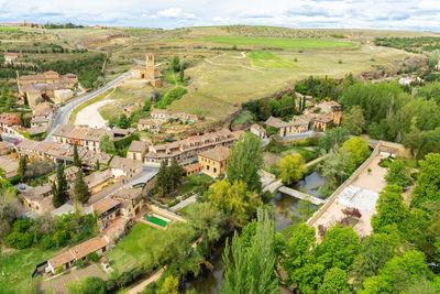 High angle view of trees and buildings in city