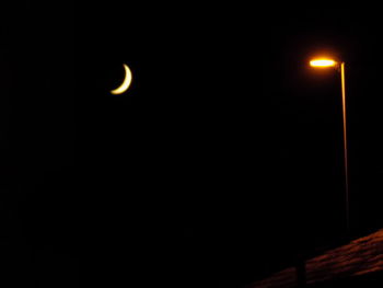 Low angle view of illuminated moon at night