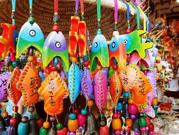 Close-up of colorful decorations hanging at market stall for sale