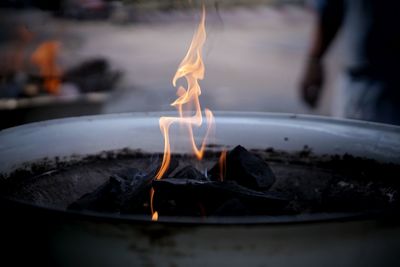 Close-up of charcoals burning in fire pit