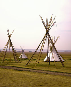 Traditional windmill on field against sky