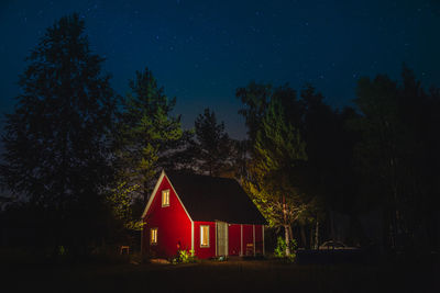 House on field against sky at night