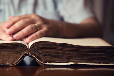 Close-up of hand on book