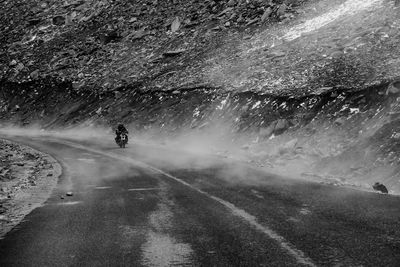 Person riding motorcycle on road