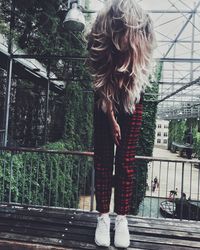 Woman standing against plants