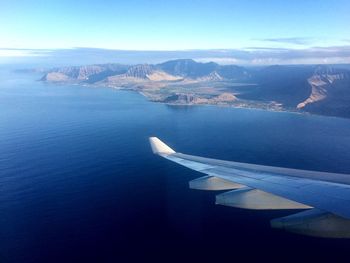 Aerial view of sea and mountains against sky