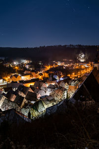High angle view of illuminated townscape against sky at night