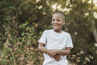 Portrait of smiling boy standing outdoors