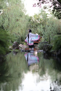 Rear view of woman in lake