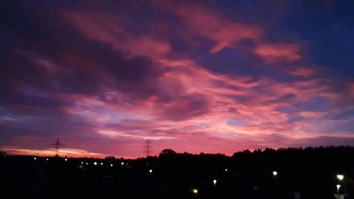 Silhouette buildings against sky at sunset