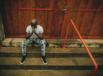 High angle view of man sitting on steps