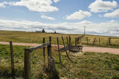 Fence on field against sky