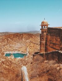 Tower on beach against clear sky