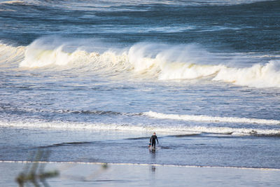 Surfer getting in the water 