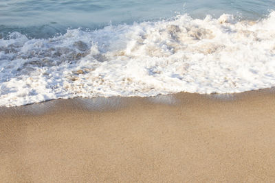 High angle view of waves rushing towards shore