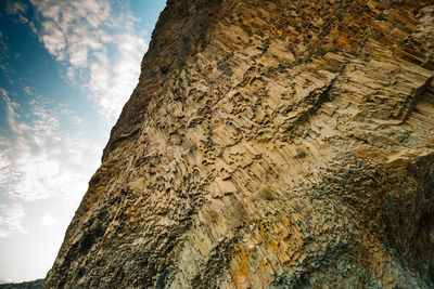 Low angle view of rock formation against sky