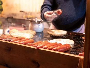 Midsection of person preparing food at market