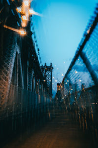 Illuminated bridge against clear blue sky at dusk