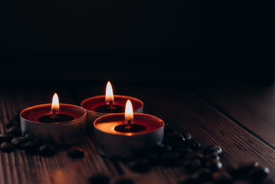 Close-up of lit candles on table