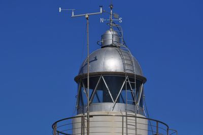 Low angle view of lighthouse against clear blue sky