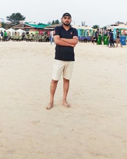 Portrait of young man standing on beach