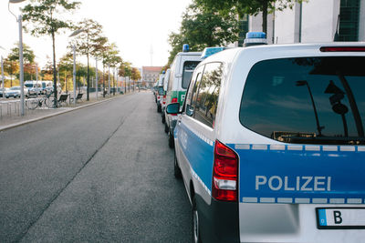 Police cars parked on street in city