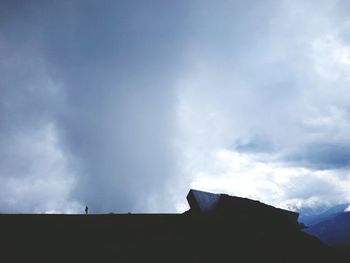 Low angle view of building against cloudy sky