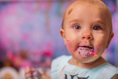 Close-up of cute girl with frosting on her face