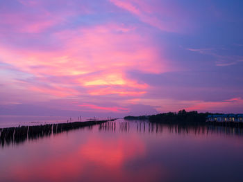 Scenic view of lake against romantic sky at sunset