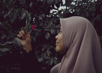 Midsection of woman holding plant