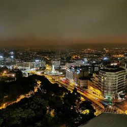 High angle view of illuminated buildings against sky at night