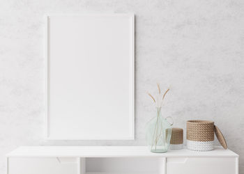 Empty vertical picture frame on white wall in modern living room. mock up interior  