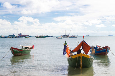 Ship moored on sea against sky