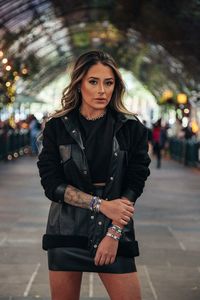 Portrait of beautiful woman standing with umbrella