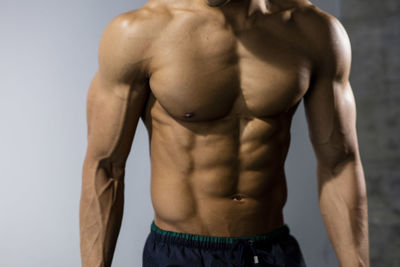 Midsection of shirtless muscular man