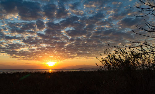 Scenic view of silhouette land against sky during sunset