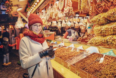 Portrait of young woman standing at market