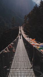 View of footbridge leading towards mountain