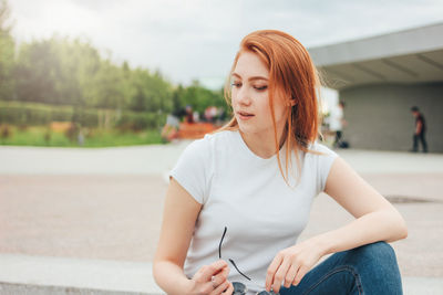 Young woman sitting outdoors