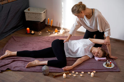 Woman sitting on floor at home