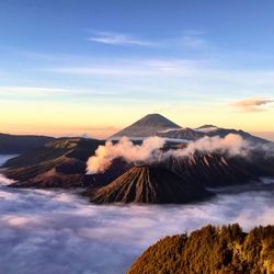 Scenic view of mountains against cloudy sky