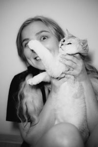 Portrait of young woman with dog at home