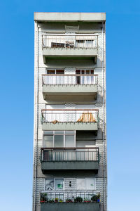 Low angle view of building against clear blue sky