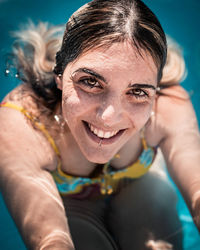 Portrait of a smiling young woman swimming pool