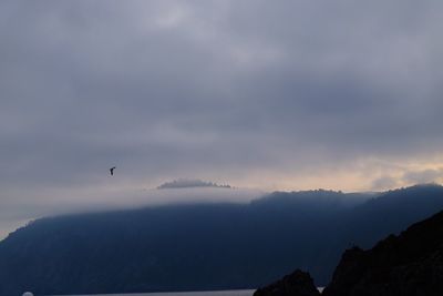 Low angle view of silhouette mountains against sky