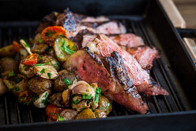 High angle view of meat on barbecue grill