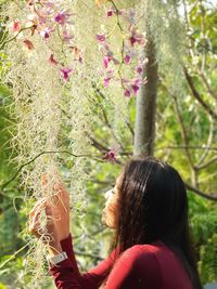 Portrait of woman on pink tree